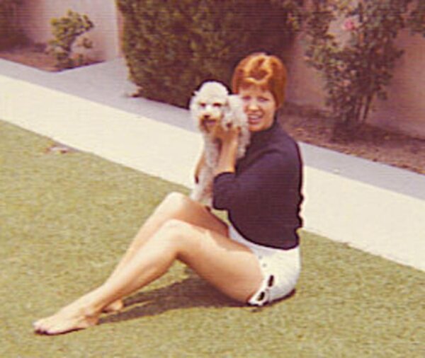 A photo of Ruth Marie Terry with a dog taken in the 1960s