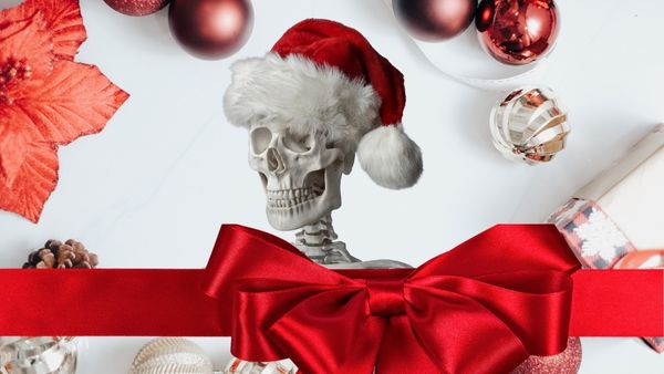 Skeleton wearing Santa hat against Christmas background with a red ribbon and box