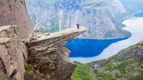 A person standing on the Trolltunga (Troll's tongue) in Norway