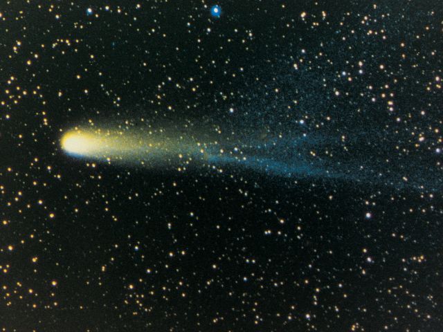 Bright green comet amidst stars