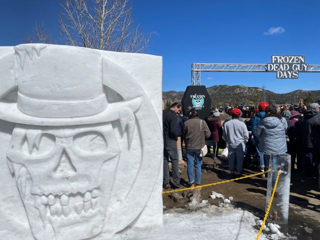 A frozen dead guy carving at the festival